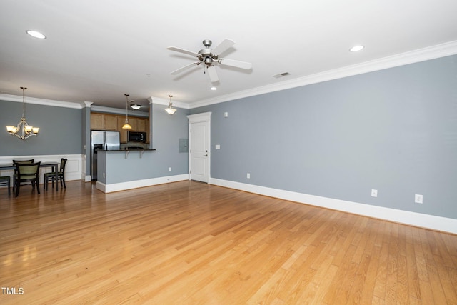 unfurnished living room featuring visible vents, baseboards, ornamental molding, and light wood finished floors