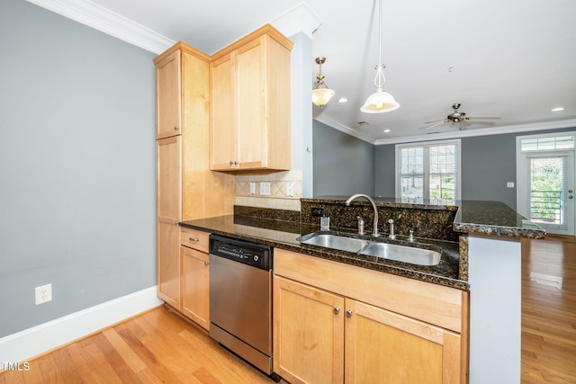 kitchen featuring dishwasher, crown molding, light brown cabinetry, and a sink