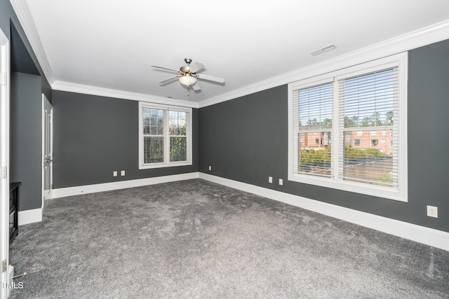 spare room with baseboards, visible vents, and ornamental molding