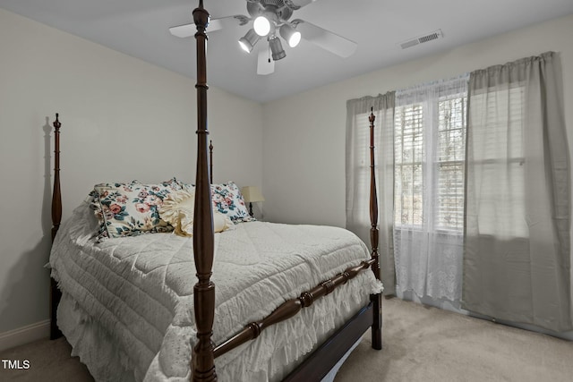 bedroom with visible vents, ceiling fan, and carpet flooring