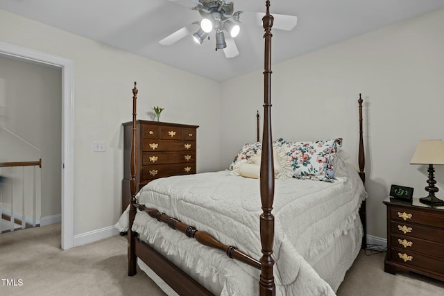 bedroom with ceiling fan, baseboards, and light carpet