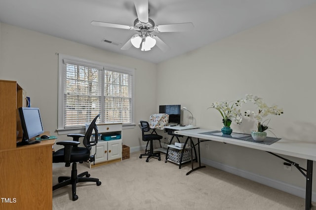 office with light carpet, visible vents, baseboards, and ceiling fan