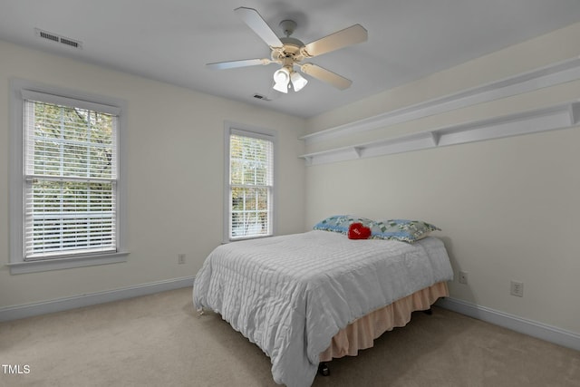 bedroom with visible vents, carpet floors, and baseboards