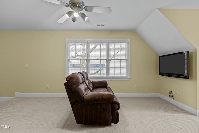 living area featuring visible vents, baseboards, lofted ceiling, and carpet floors