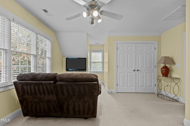 living room featuring visible vents, baseboards, ceiling fan, and carpet floors