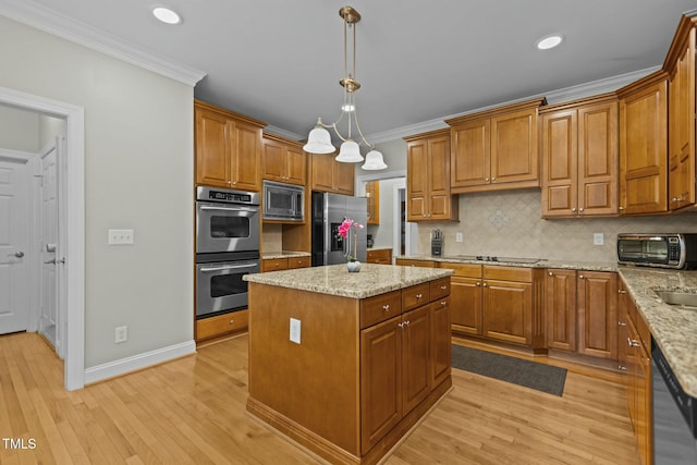 kitchen featuring brown cabinetry, appliances with stainless steel finishes, and crown molding