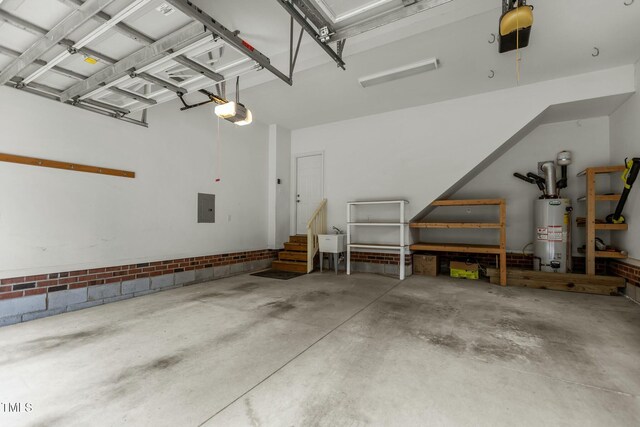 garage featuring gas water heater, electric panel, a garage door opener, and a sink