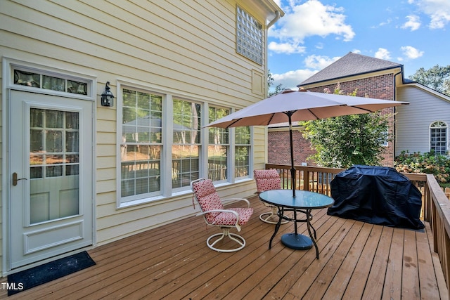 wooden deck featuring area for grilling