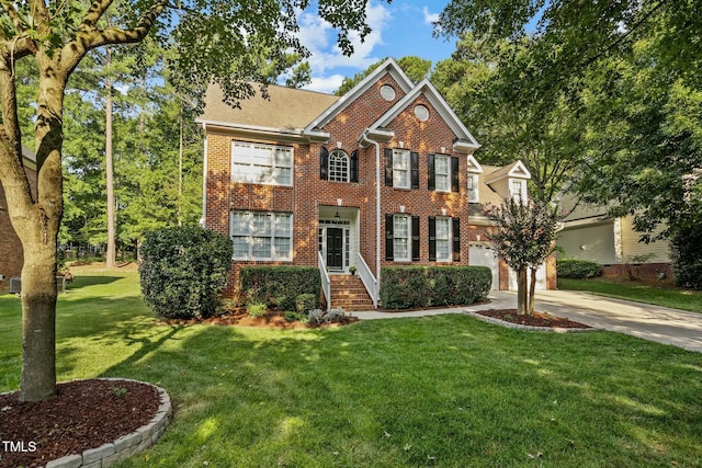 colonial house featuring brick siding, driveway, an attached garage, and a front yard