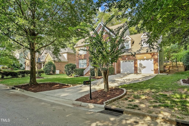 view of front of property featuring a front lawn, fence, concrete driveway, a garage, and brick siding