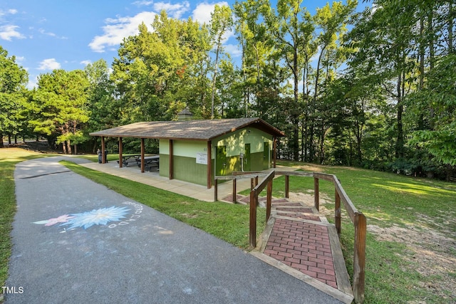 view of home's community featuring a yard and an outdoor structure