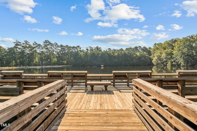 dock area featuring a forest view and a water view