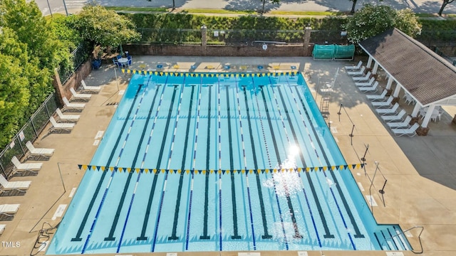 view of pool featuring fence