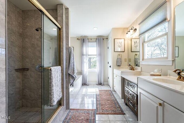 bathroom featuring vanity, a shower stall, and tile patterned floors