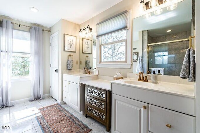 full bath with tile patterned floors, baseboards, vanity, and a shower stall