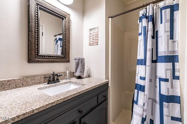 bathroom featuring curtained shower and vanity