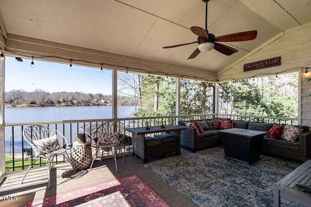 exterior space with vaulted ceiling, ceiling fan, and a water view