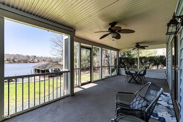 sunroom featuring plenty of natural light and a water view