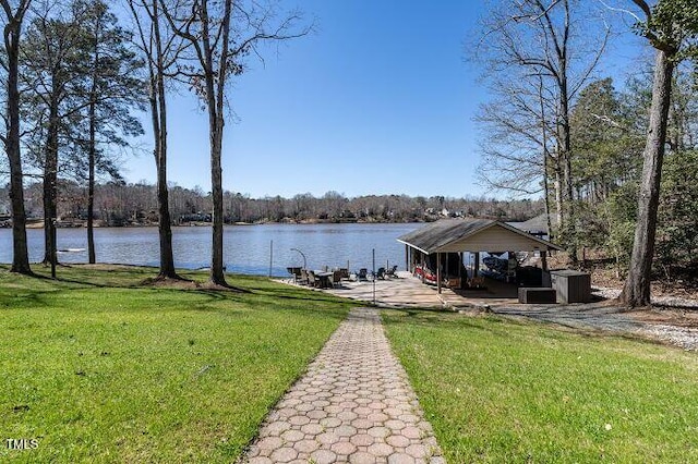 dock area with a yard and a water view