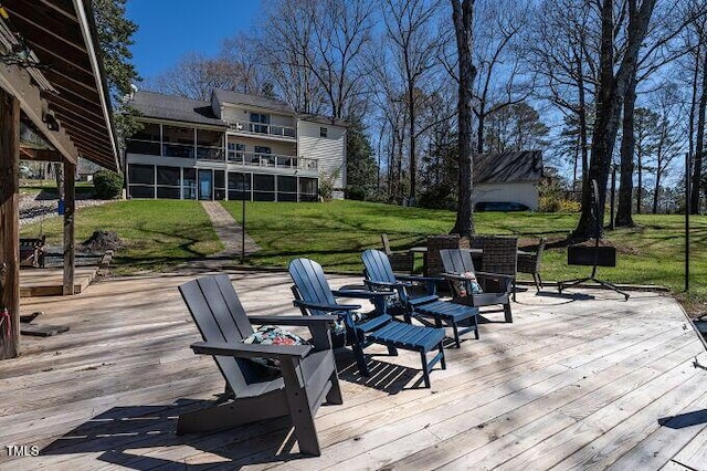 deck featuring a lawn and a sunroom