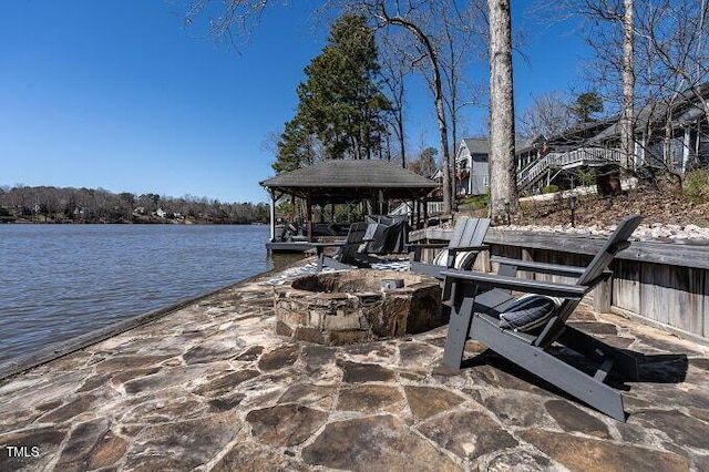 dock area featuring a water view and an outdoor fire pit