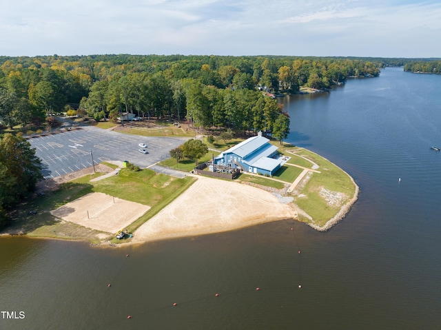 birds eye view of property with a forest view and a water view