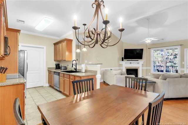 dining space with visible vents, ornamental molding, light tile patterned floors, ceiling fan with notable chandelier, and a fireplace