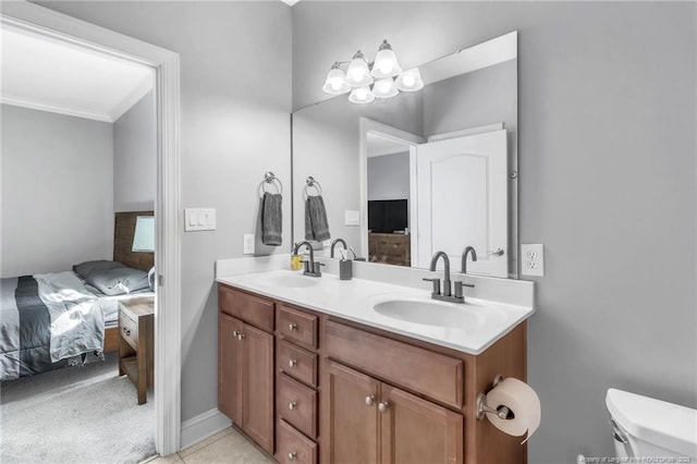 full bath with double vanity, toilet, ensuite bathroom, and a sink