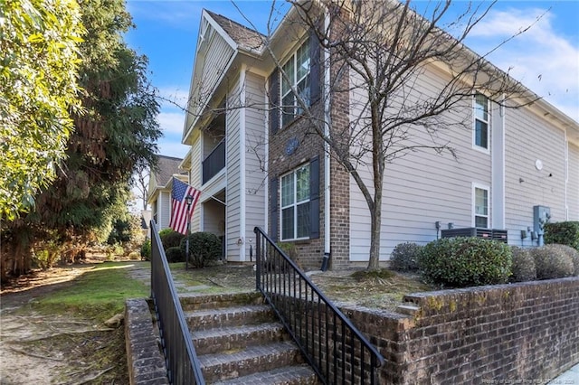 view of side of property featuring brick siding