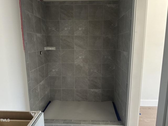 bathroom with tiled shower