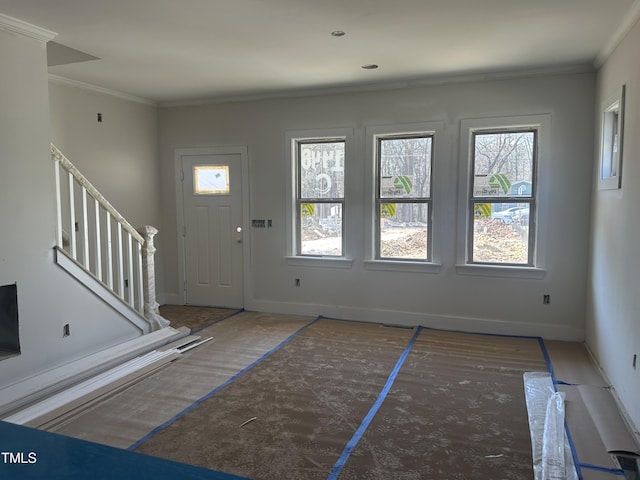 foyer featuring stairway, crown molding, and baseboards