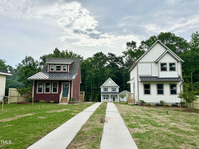 view of front of home featuring board and batten siding, a standing seam roof, and metal roof