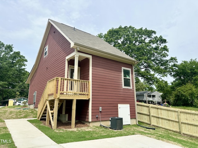 back of house featuring fence, a wooden deck, stairs, and cooling unit