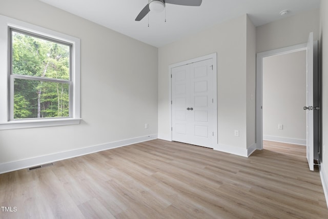 1448C Maplewood Dr, Durham, NC 27704 - unfurnished bedroom featuring light wood-style flooring, baseboards, a closet, and a ceiling fan