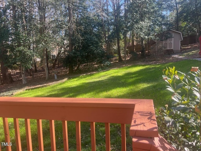 view of yard featuring a shed and an outdoor structure