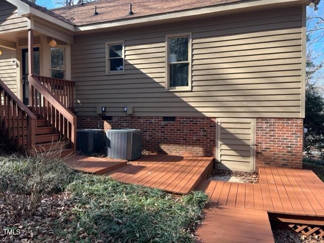 wooden deck with central air condition unit