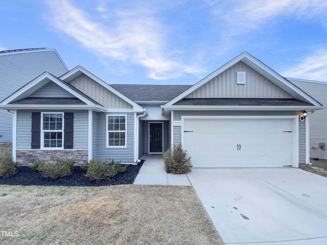 view of front of house with a garage, stone siding, board and batten siding, and concrete driveway