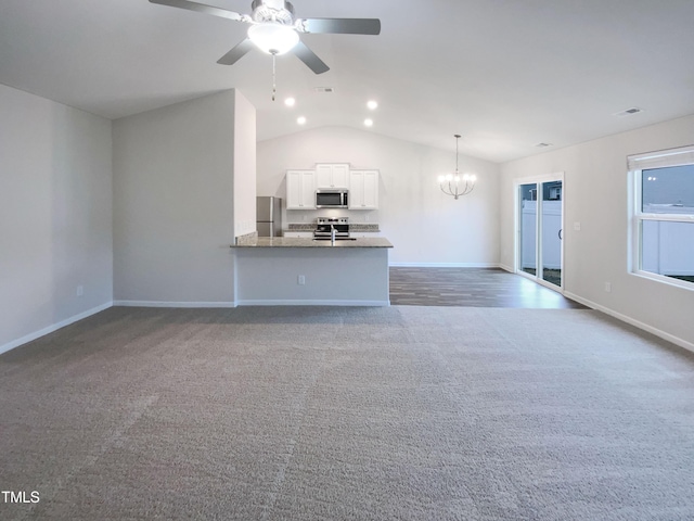 unfurnished living room with visible vents, baseboards, lofted ceiling, carpet floors, and ceiling fan with notable chandelier