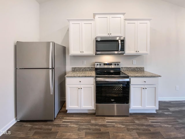 kitchen with dark wood-type flooring, baseboards, light stone countertops, white cabinets, and stainless steel appliances