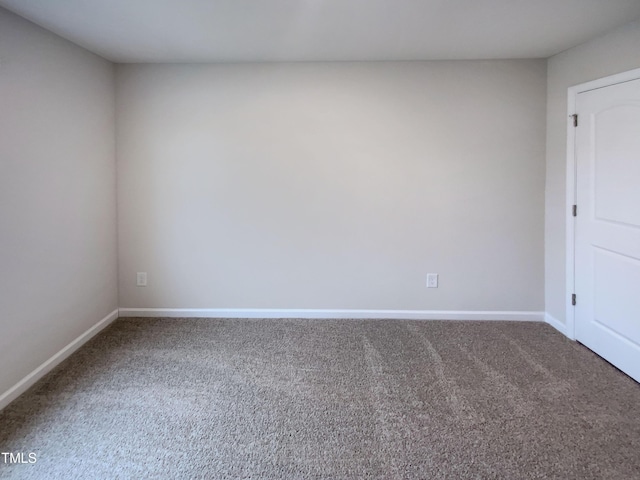 spare room with carpet flooring and baseboards