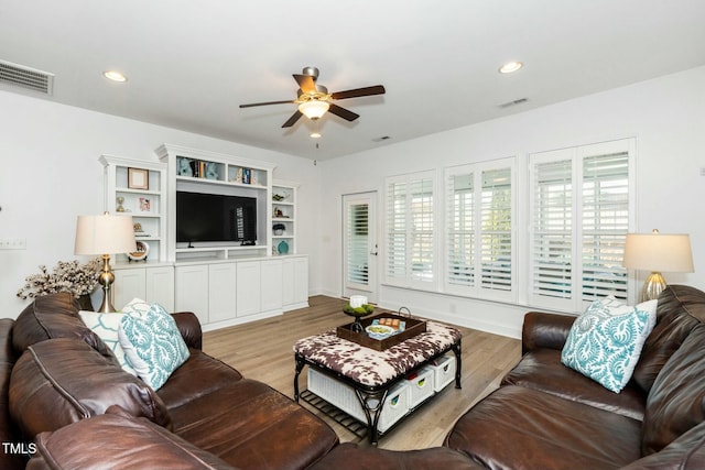 living area with recessed lighting, visible vents, light wood-style flooring, and ceiling fan