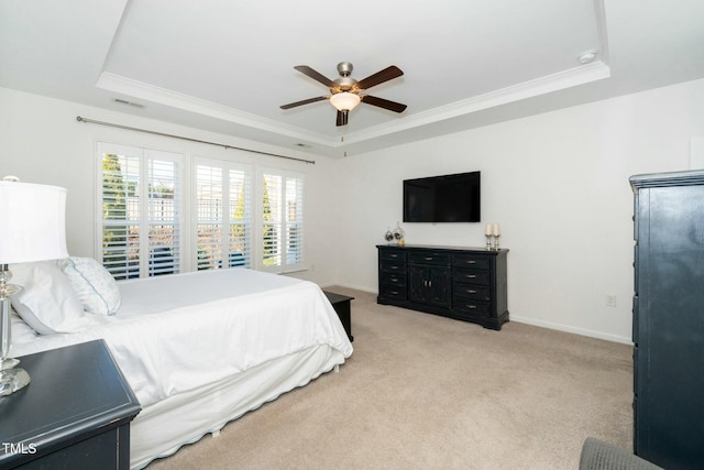 bedroom featuring a raised ceiling, a ceiling fan, crown molding, baseboards, and light colored carpet