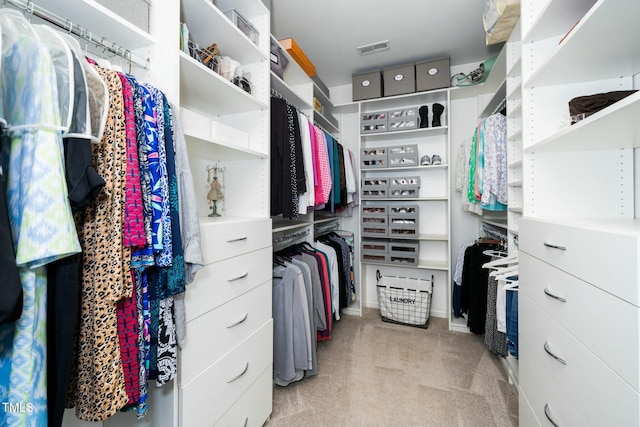 spacious closet featuring visible vents and light colored carpet