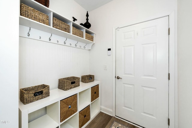 mudroom with baseboards and dark wood-style flooring