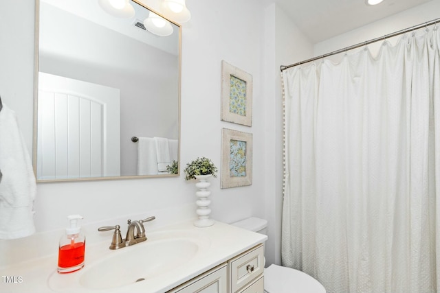 full bath with visible vents, toilet, and vanity