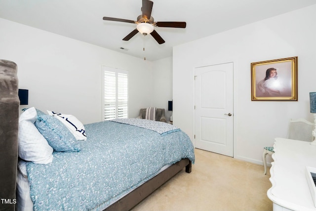 carpeted bedroom featuring visible vents, baseboards, and a ceiling fan