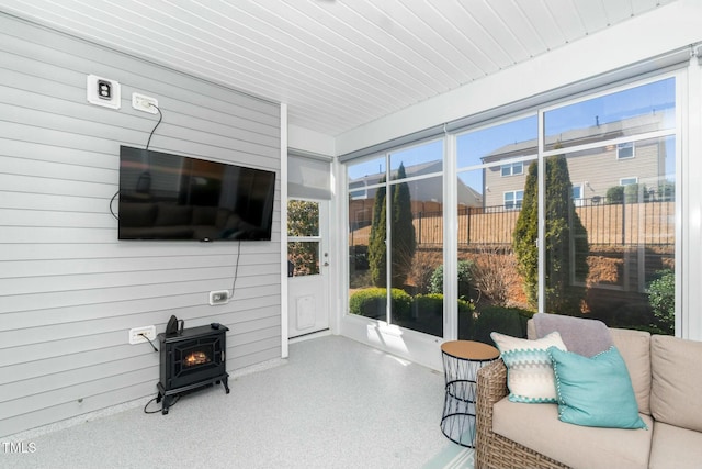 sunroom / solarium featuring a wood stove