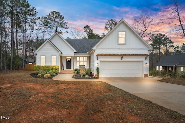 view of front of house with a garage, board and batten siding, concrete driveway, and a shingled roof