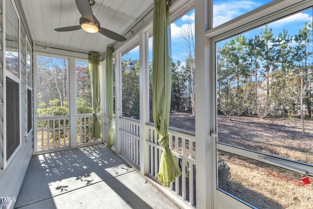 sunroom / solarium with ceiling fan and wooden ceiling