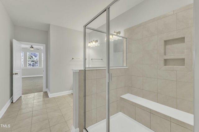 full bathroom featuring a shower stall, baseboards, and tile patterned floors